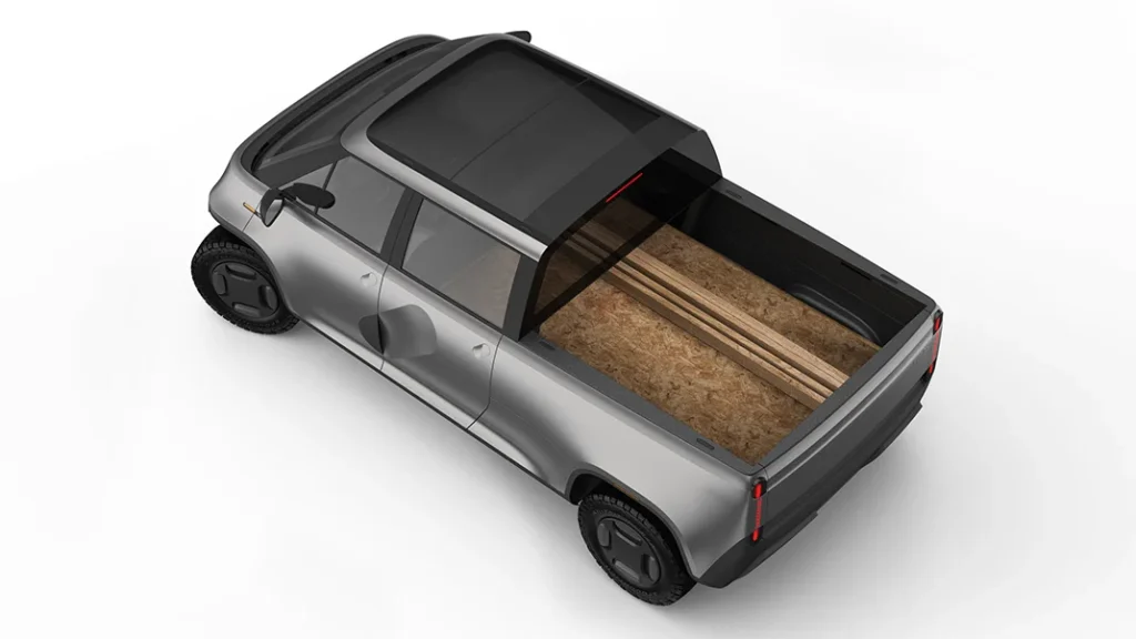 An image of a truck approximately the size of a Mini cooper. A sheet of plywood extends under the rear window and into the back seats.