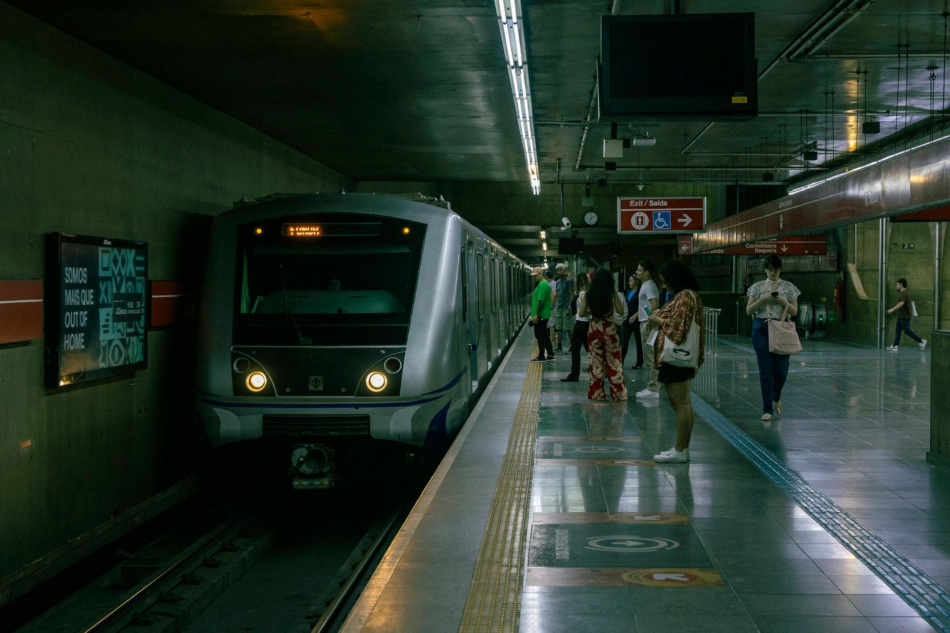 sao paulo subway station with train and passengers